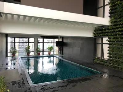 a swimming pool in the middle of a building at STAYLUXIA BOUTIQUE HOTEL GRAMERCY Balcony FREE Pool, Gym, Netflix in Manila
