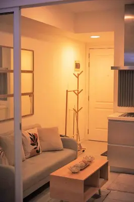 a living room with a couch and a coffee table at Cozy Tahanan Azure Studio close to NAIA in Manila