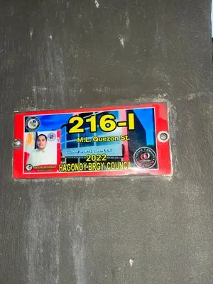 a license plate with a picture of a man at Liza homestay in Manila