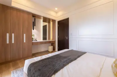 a bedroom with a large bed and a bathroom at Modern Condo at Park McKinley West with Wi-Fi and Washer in Manila
