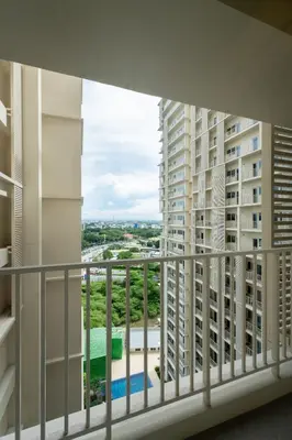 a balcony with a view of some buildings at Modern Condo at Park McKinley West with Wi-Fi and Washer in Manila