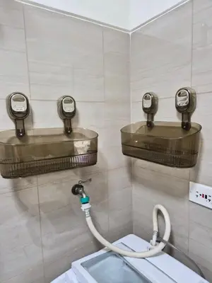 a bathroom with a hose hooked up to a toilet at Zen 2 Shore A Residences in Manila