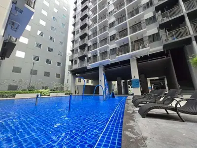a swimming pool in front of a building at Chic Urban Escape at S Residence Tower 3 in Manila