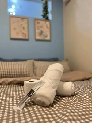 a roll of toilet paper with a fork on a bed at Chic Urban Escape at S Residence Tower 3 in Manila