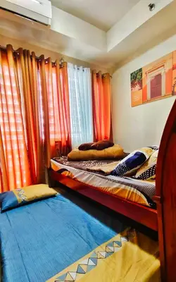 two bunk beds in a room with curtains at JandG MOA Staycation Amenity view at Shell residence in Manila