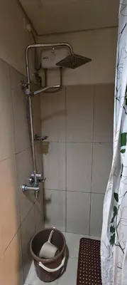 a bathroom with a shower with a toilet in it at JandG MOA Staycation Amenity view at Shell residence in Manila