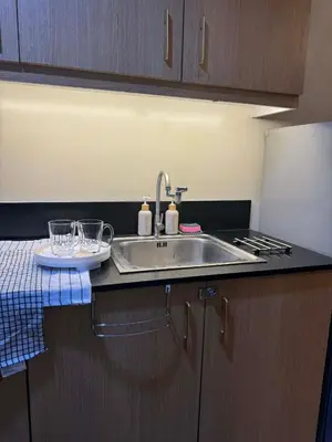 a kitchen with a sink and a counter top at Dusk Suites elevated escapes at Shell Residences, Mall of Asia Complex in Manila