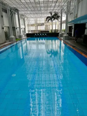 a large swimming pool with blue tiles on the floor at Prime Makati Condo Near Poblacion & Malls in Manila