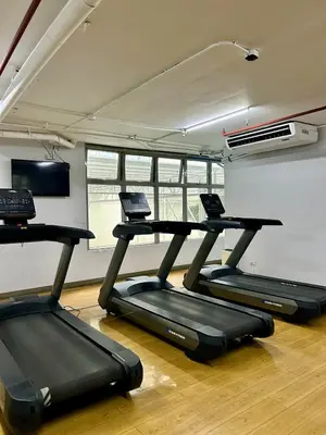 a gym with two treadmills in a room at Prime Makati Condo Near Poblacion & Malls in Manila