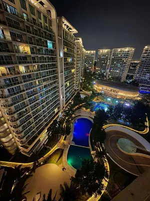 a view of a city at night with tall buildings at The Warm Suite By ANC at Azure in Manila