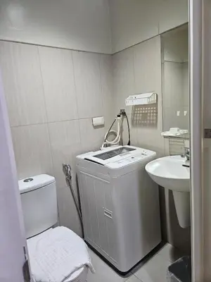 a white bathroom with a sink and a toilet at Shell MOA Facing View 1BR near Ikea, NAIA, PICC Shell003 in Manila