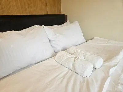 a white bed with white sheets and pillows at Shell MOA Facing View 1BR near Ikea, NAIA, PICC Shell003 in Manila