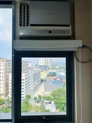 a window with a television and a microwave at Minimalist 1BR Condo at Araneta City, Cubao in Manila