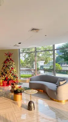 a living room with a christmas tree and a couch at 3 min to Rockwell City View Pool Parking in Manila