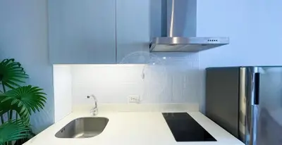 a kitchen with a sink and a stainless steel refrigerator at 3 min to Rockwell City View Pool Parking in Manila