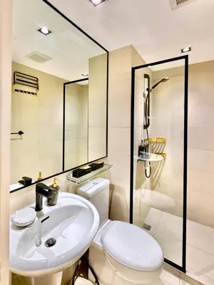 a bathroom with a white toilet and a sink at Azure Urban Resort 1BR-2BR St Tropez in Manila