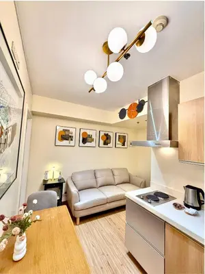 a living room with a couch and a table at Azure Urban Resort 1BR-2BR St Tropez in Manila