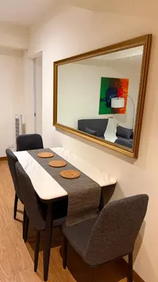 a dining room table with chairs and a large mirror at Azure Urban Resort 1BR-2BR Boracay in Manila