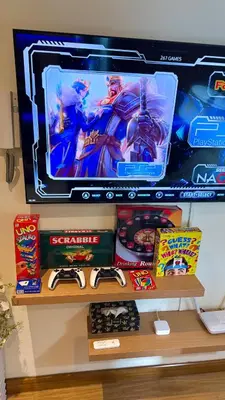 a computer monitor on top of a shelf with toys at Azure Urban Resort 1BR-2BR Boracay in Manila
