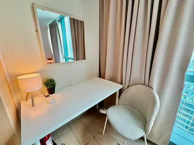 a white desk with two chairs and a mirror at 1BR at One Uptown Residence BGC Across Uptown Mall in Manila