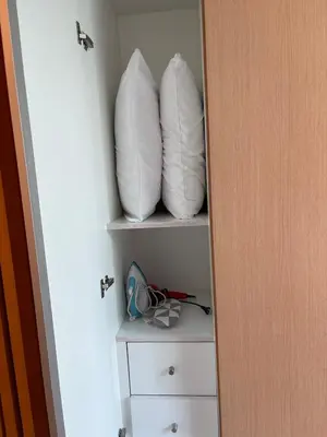 two pillows sitting on a shelf in a closet at 1BR at One Uptown Residence BGC Across Uptown Mall in Manila
