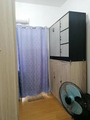 a room with a fan next to a cabinet at Aureascondo in Manila