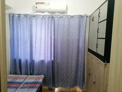 a purple shower curtain in a room with a bed at Aureascondo in Manila