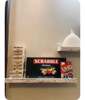 a shelf with a book and a box of srirachaiction at Staycay at SRESIDENCES in Manila