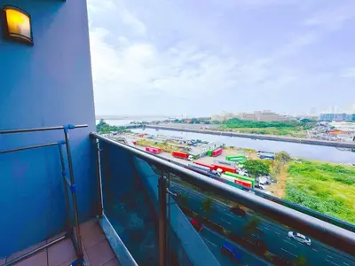 a balcony with a view of a river and a train at Manila bay view Shore2 Two bedrooms in Manila
