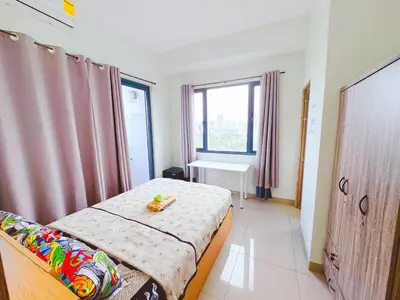 a small bedroom with a bed and a window at Manila bay view Shore2 Two bedrooms in Manila