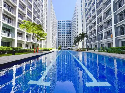 a swimming pool in a city with tall buildings at Manila bay view Shore2 Two bedrooms in Manila
