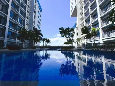 a swimming pool in the middle of two tall buildings at Manila bay view Shore2 Two bedrooms in Manila