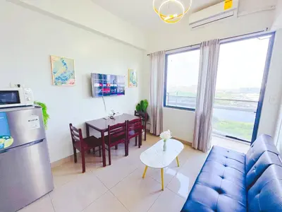 a living room with a blue couch and a table at Manila bay view Shore2 Two bedrooms in Manila