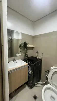 a bathroom with a sink and a toilet at Shore Recidences Mall Of Asia Cullen in Manila