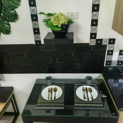 a table with two plates with gold spoons on them at Shore Recidences Mall Of Asia Cullen in Manila