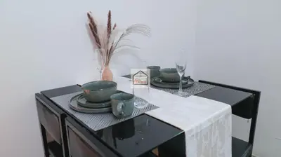 a table with plates and cups on top of it at Aludia's Dreamplace in Manila