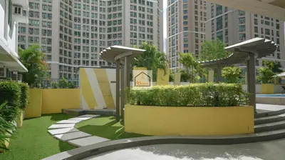 a courtyard in a city with tall buildings at Aludia's Dreamplace in Manila