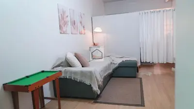 a living room with a couch and a pool table at Aludia's Dreamplace in Manila