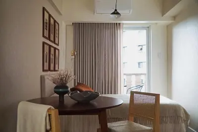 a dining room with a table and a window at The Florentine Suite in Manila