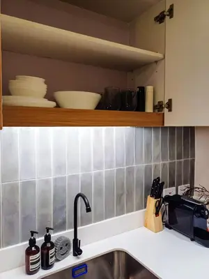 a kitchen counter with a sink and a microwave at The Florentine Suite in Manila