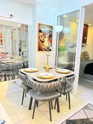 a dining room with a table and chairs at Ohana JPL Azure Staycation in Manila