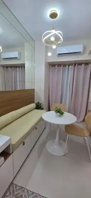 a dining room with a table and a mirror at The Shore 3 Chic Suite in Manila