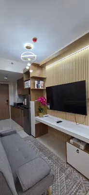 a living room with a large flat screen tv at The Shore 3 Chic Suite in Manila