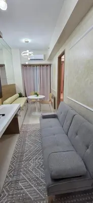a living room with a couch and a table at The Shore 3 Chic Suite in Manila