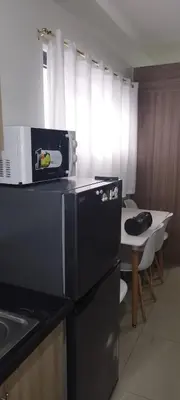a kitchen with a black refrigerator and a table at SM Mall of Asia Shore2 Tower2 Nano Nap&Go in Manila