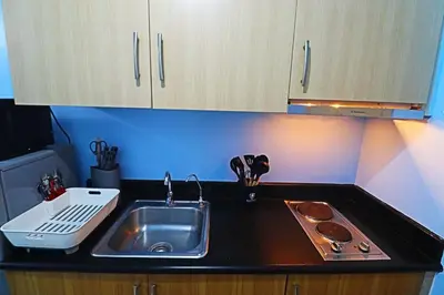 a kitchen with a sink and a counter top at Comfy 1BR Self Check-In at Light Residences in Manila
