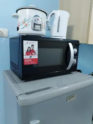 a microwave sitting on top of a refrigerator at Comfy 1BR Self Check-In at Light Residences in Manila