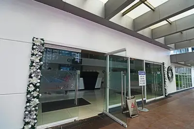 a lobby with glass doors and flowers on the wall at Comfy 1BR Self Check-In at Light Residences in Manila