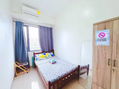 a small bedroom with a bed and a window at City Center Near Mall BIG 2 BEDROOM 2 RESTROOM City View Family-Friendly SHORE 2 RESIDENCE Tower 1 in Manila