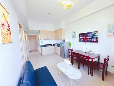 a living room with a blue couch and a table at City Center Near Mall BIG 2 BEDROOM 2 RESTROOM City View Family-Friendly SHORE 2 RESIDENCE Tower 1 in Manila